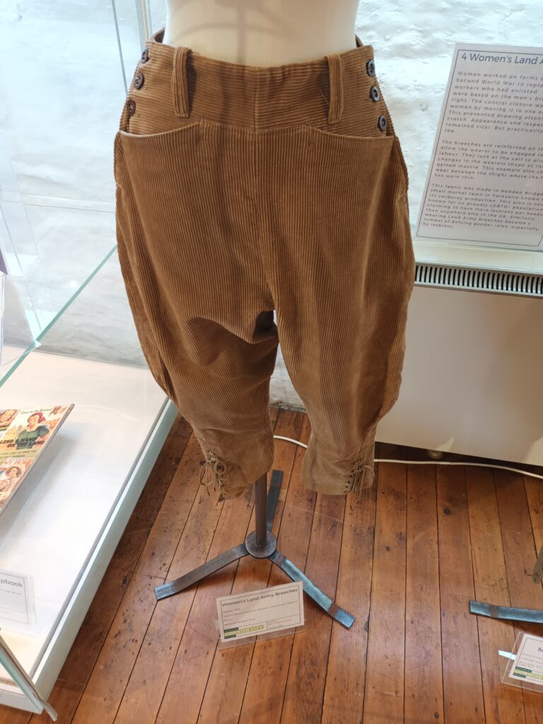 A pair of brown Corduroy breeches with side fasterning designed for the Women's Land Army, on display as part of Stories Told in Stitches Exhbition.