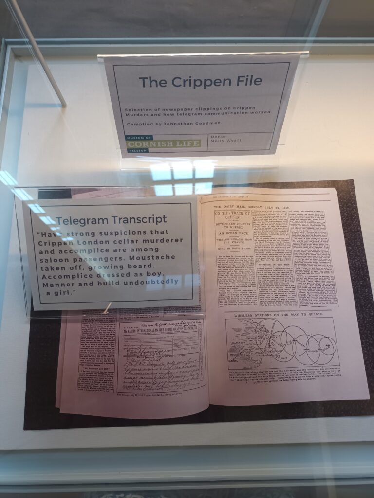 Photo of original telepram informing of Le Neve with translation typed next to in in display case reading: 'Have strong suspicions that Crippen London cellar murderer and accomplice are among saloon passengers. Moustache taken off, growing beard. Accomplice dressed as a boy. Manner and build undoubtedly a girl'