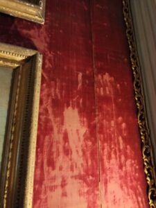 Fragile worn red velvet wallpaper